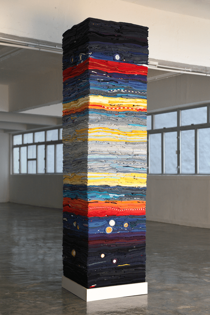 Atmosphere, 2019Size: 8′ x 2′ x 2′ (H x W x D)Materials: Second hand clothing, wood and steel.